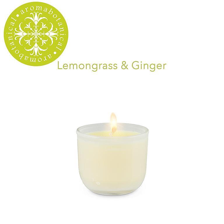 A white, square-shaped candle with a flickering flame, labeled 'Lemongrass & Ginger' from the brand Aromabotanical.
