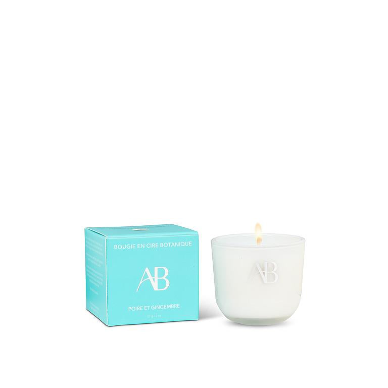 White candle with a lit wick next to a turquoise box on a white background