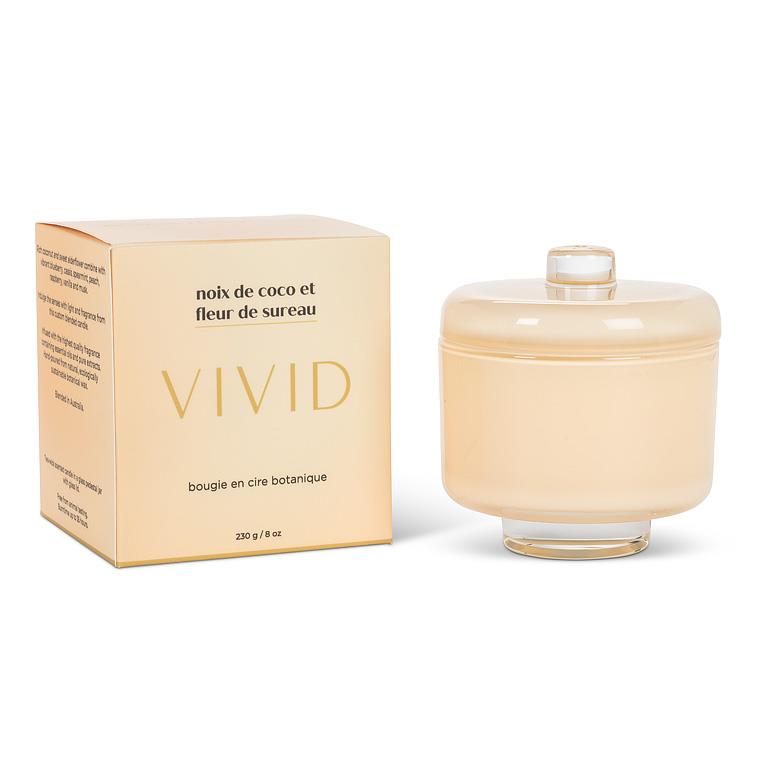 Beige candle with lid and packaging labeled 'VIVID' on a white background