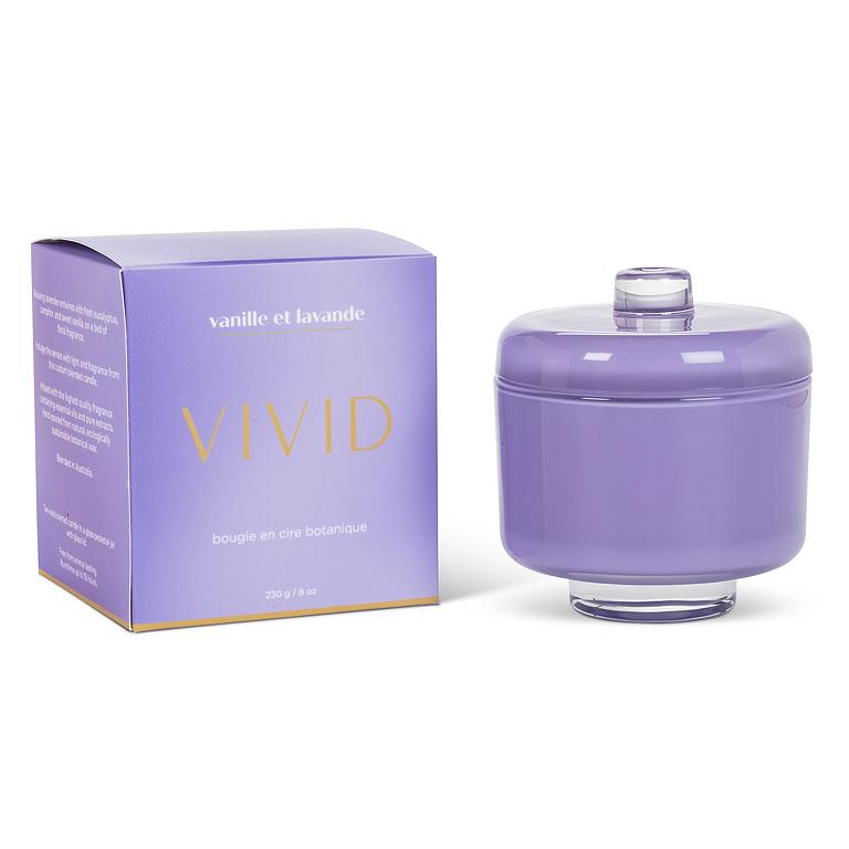 Purple candle with lid and packaging labeled 'Vivid' on a white background