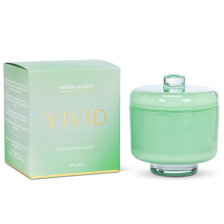 Green candle with lid and packaging labeled 'Vivid' on a white background
