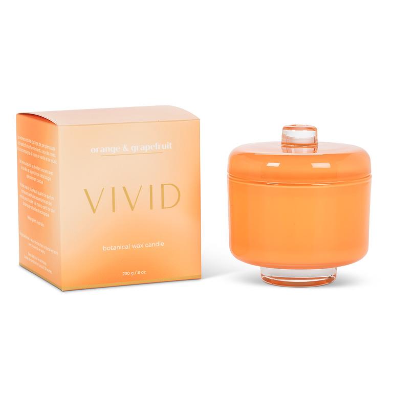 Orange candle with matching packaging on a white background