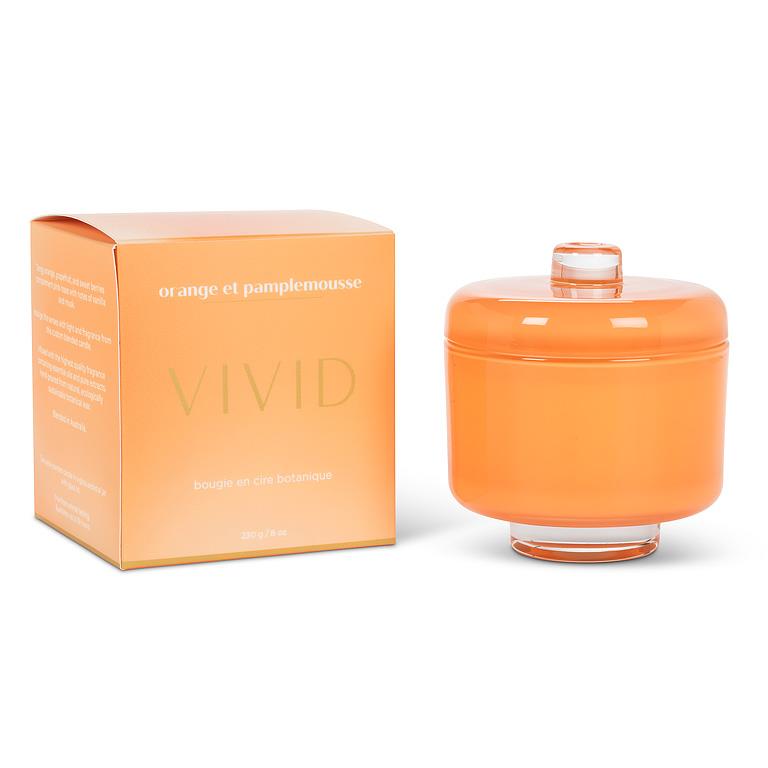 Orange candle with matching packaging on a white background