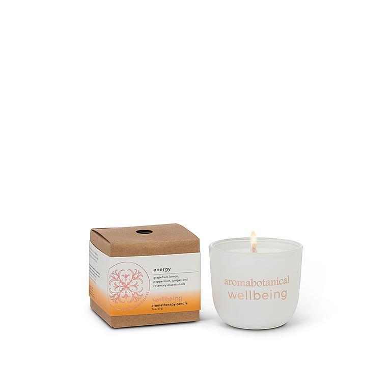 A white, 2-inch diameter Aromabotanical Energy Wellbeing Aromatherapy Candle with a brown packaging box in the background.