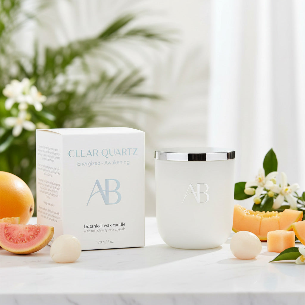 AB candle and packaging on a marble surface with fruits and flowers
