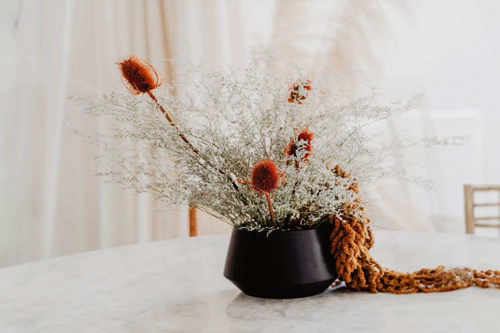 Pot with flowers on a table