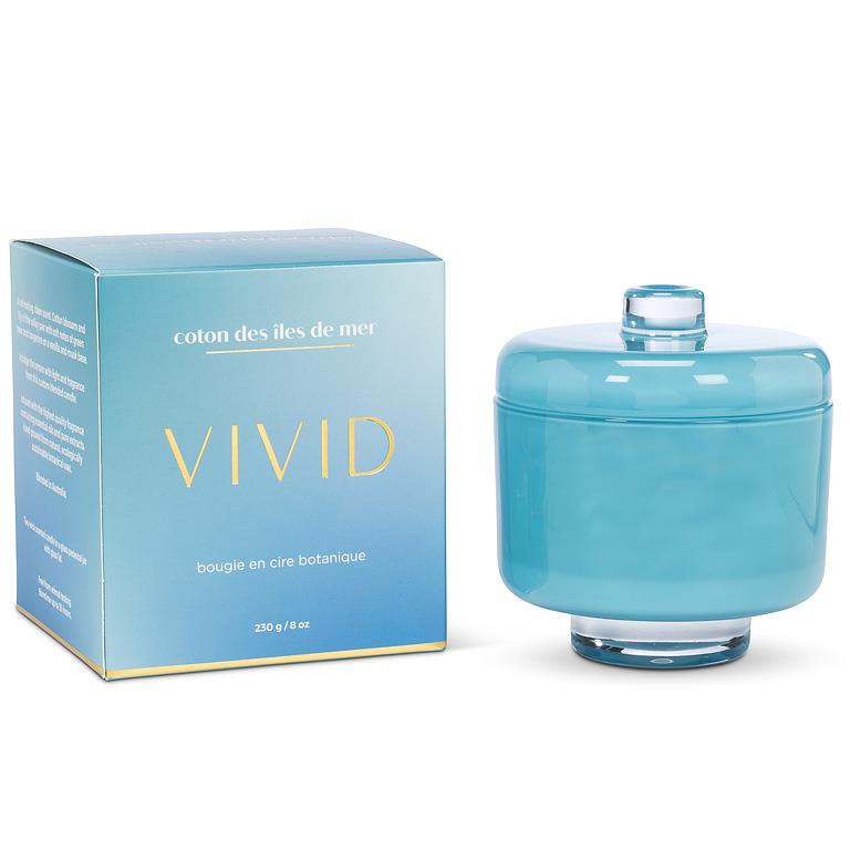 Blue candle with lid and matching box labeled 'VIVID' on a white background