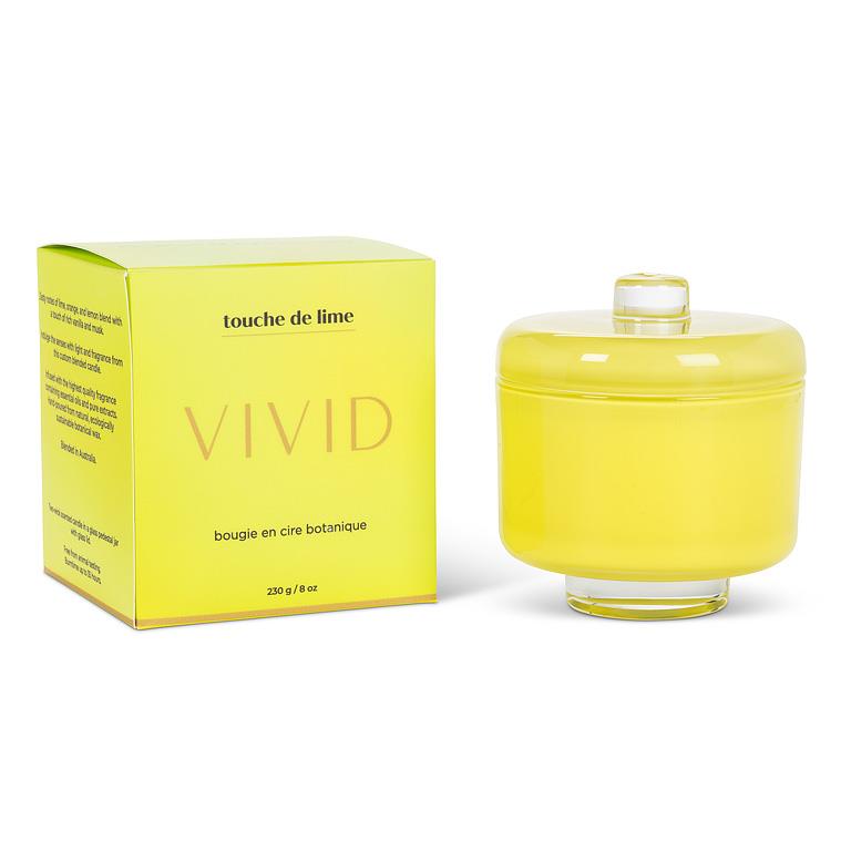 Yellow candle with a matching box labeled 'Vivid' on a white background